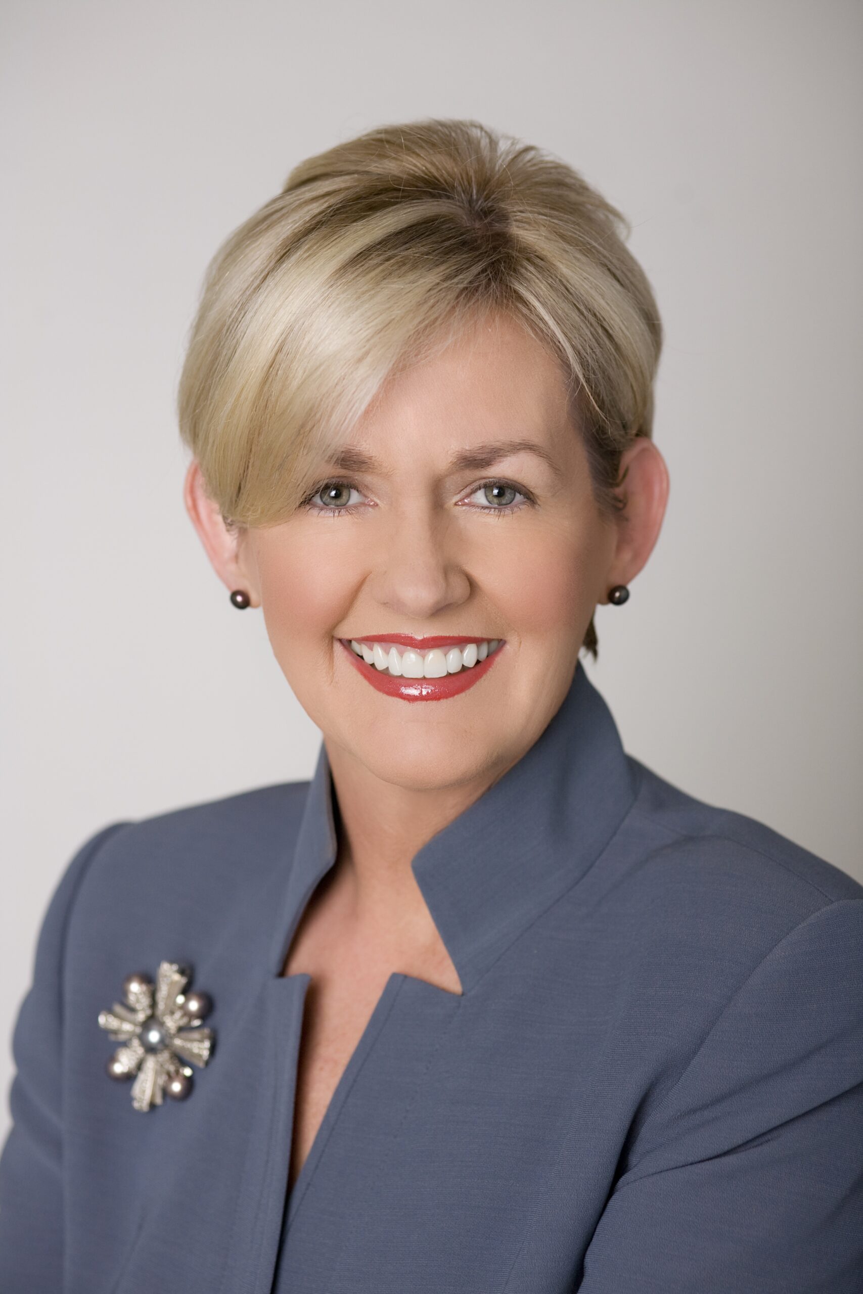 Smiling headshot of a woman with plain background