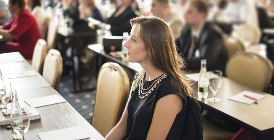 A woman closeup shot sitting in a conference