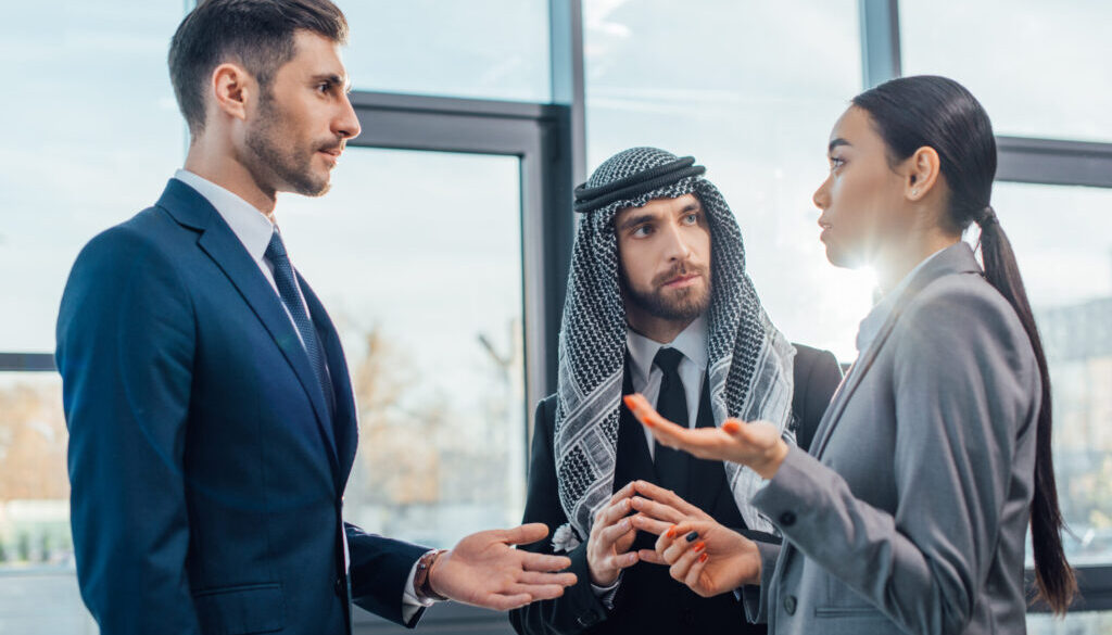 View of two men and a woman discussing